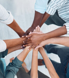 Diversity, hands and team above in support, trust and unity for collaboration, agreement or meeting at the office. Group hand of diverse people in teamwork, cooperation and solidarity