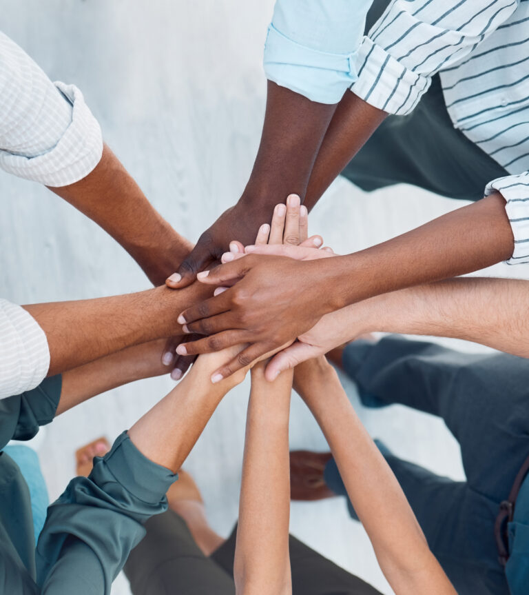 Diversity, hands and team above in support, trust and unity for collaboration, agreement or meeting at the office. Group hand of diverse people in teamwork, cooperation and solidarity