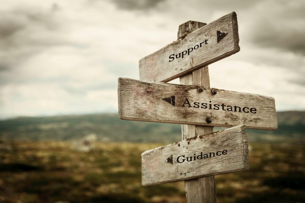 Signpost pointing toward support, assistance, and guidance when you are stuck in the same patterns